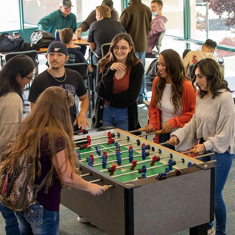 火博体育 students playing foosball in the Suns Student Lounge.