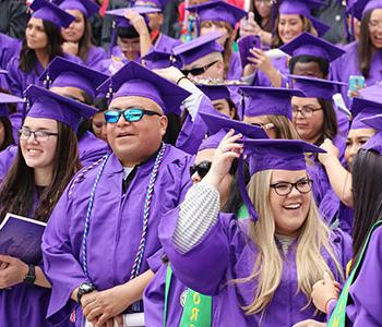 Students in cap and gown at graduation.